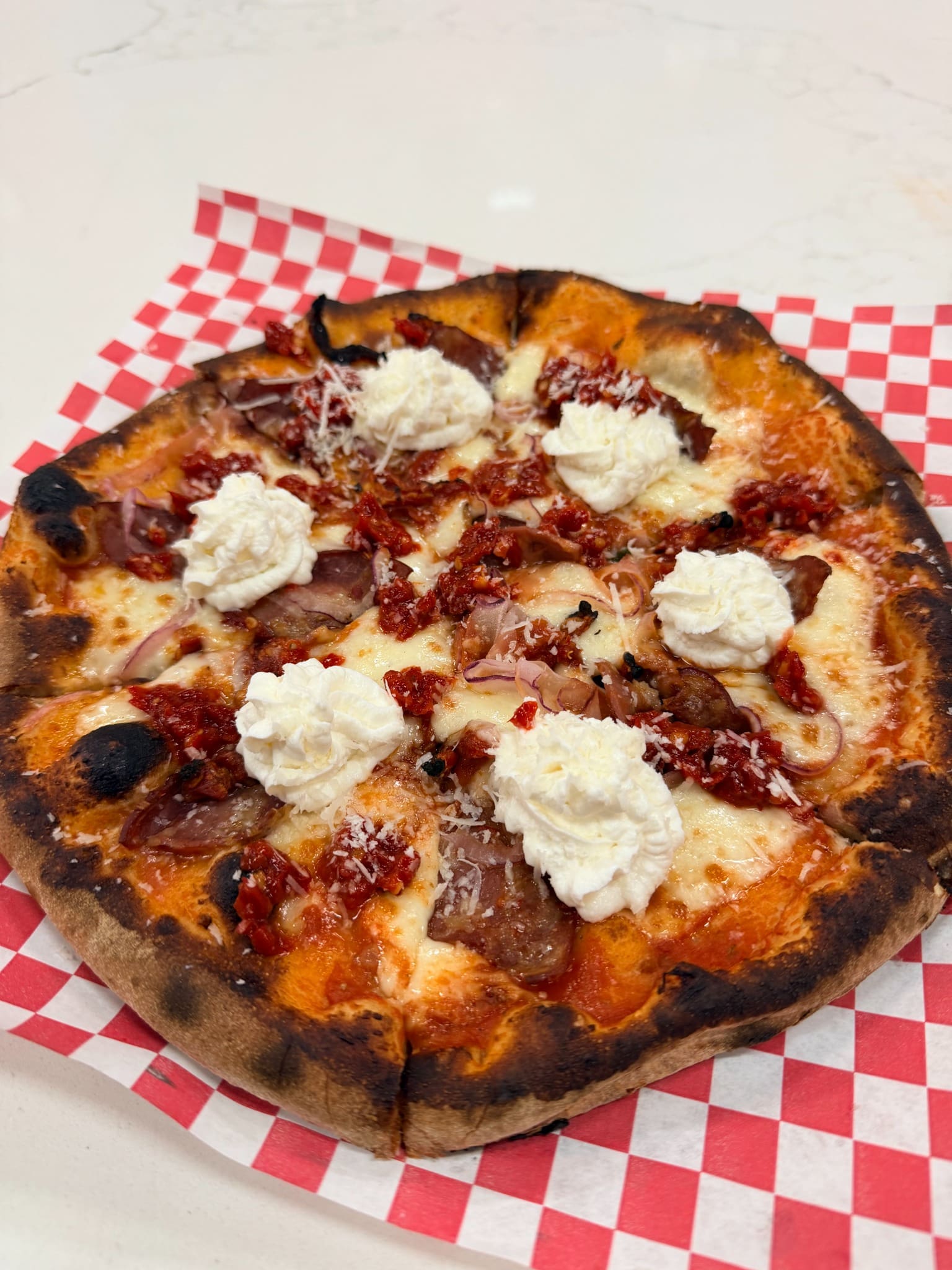 Spicy Calabrian pizza with whipped ricotta and capicola