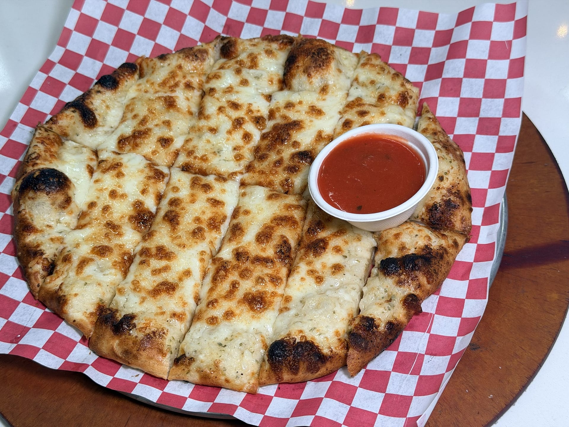 Cheesy breadsticks with tomato dipping sauce at Margherita Pizza